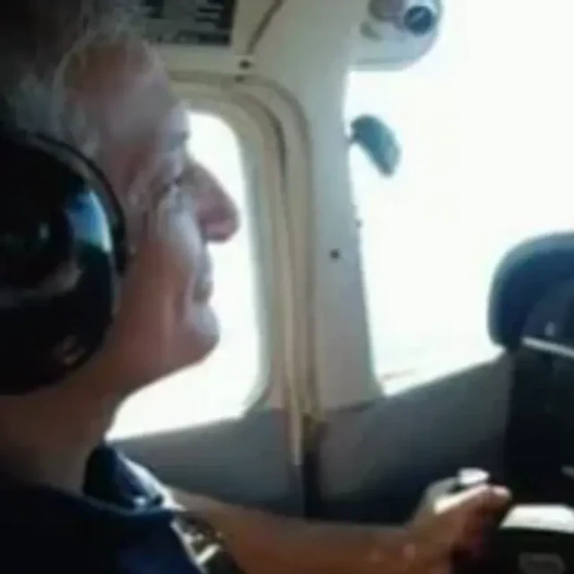 Mark Clark wearing a headset in a cockpit